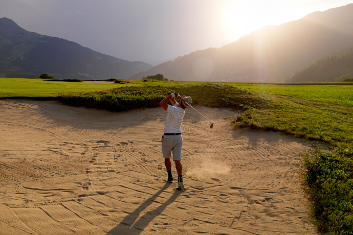 Golferlebnis am jungen Rhein: die abwechslungsreiche 18-Loch-Anlage von Sagogn-Schluein liegt am Vorderrhein (Foto: © Alfonso Smith) Ein Golfer spielt einen Ball aus dem Bunker auf dem Golfplatz Sagogn in der Surselva